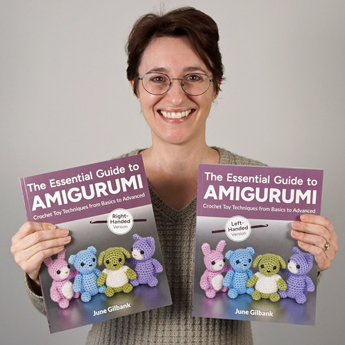 Author June Gilbank holding the right- and left-handed versions of The Essential Guide to Amigurumi paperback books